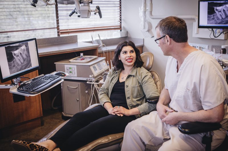 Dr. Kramp talking to a patient about an upcoming dental treatment