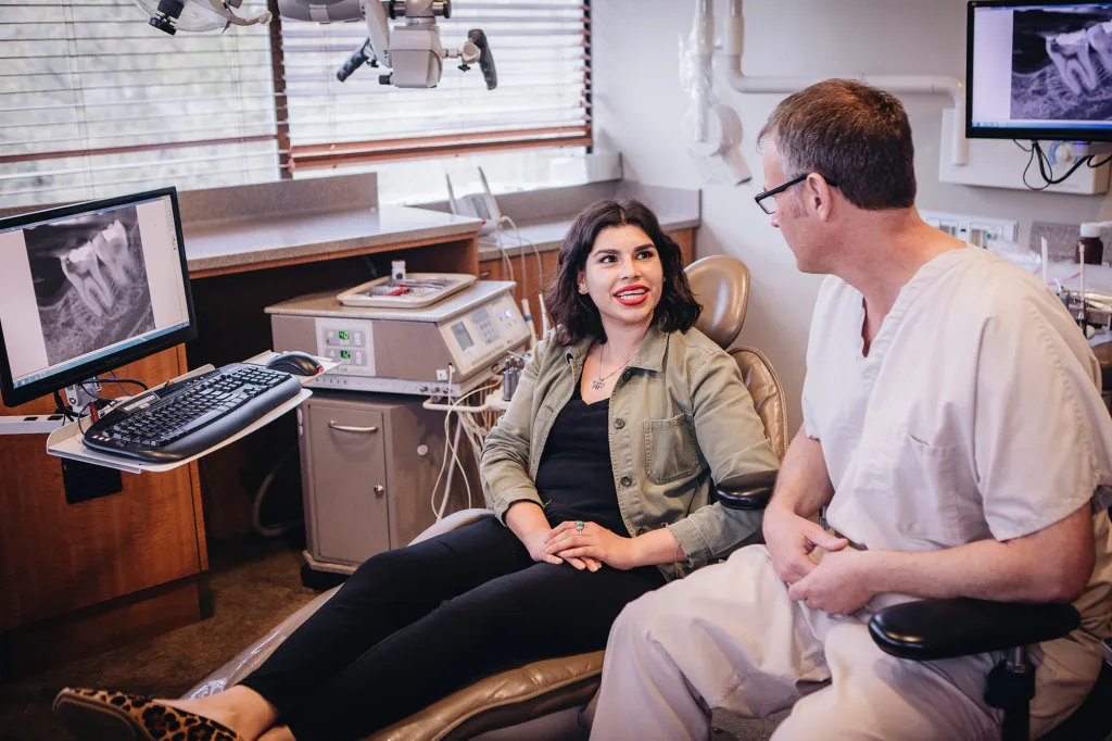 Dr. Kramp talking to a patient about an upcoming dental treatment